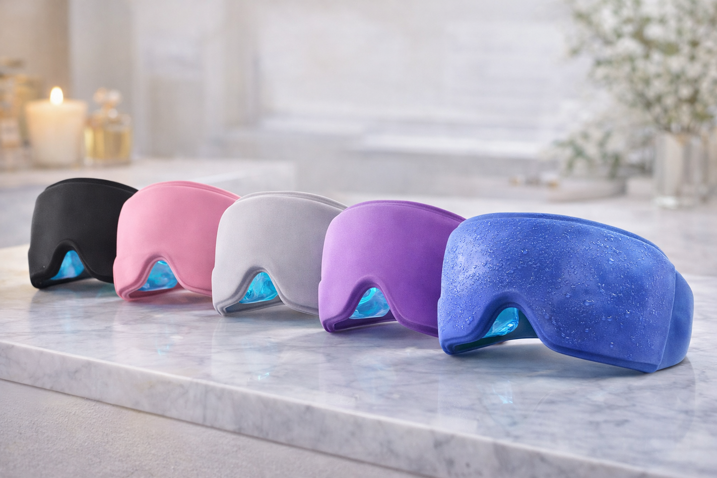 Five colorful eye masks on a marble surface with a blurred background